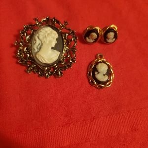 Brooch, earrings, and necklace charm